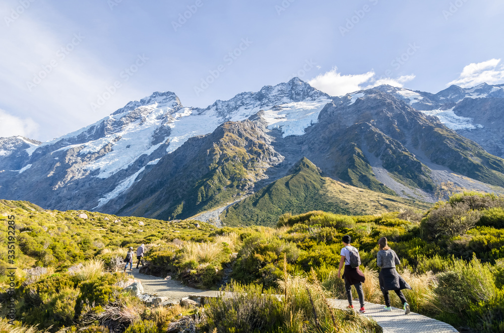 Travelers can seen trekking to the Mount Cook National Park,New Zealand