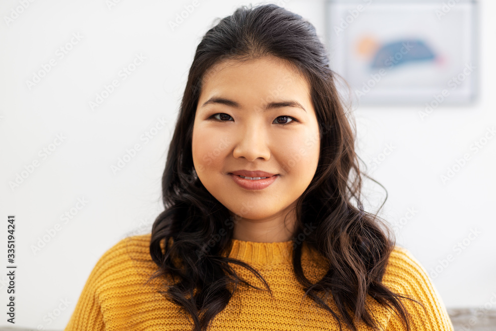 people, ethnicity and race concept - portrait of happy smiling asian young woman at home people, ethnicity and race concept - portrait of happy smiling asian young woman at home