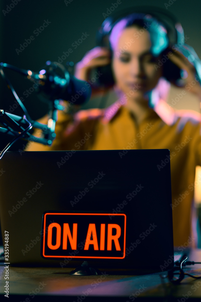 Young radio host getting ready for broadcasting Photos | Adobe Stock
