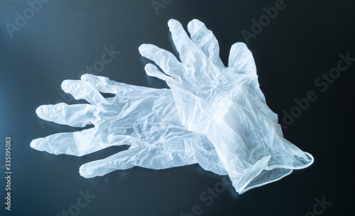 White medical gloves on black background