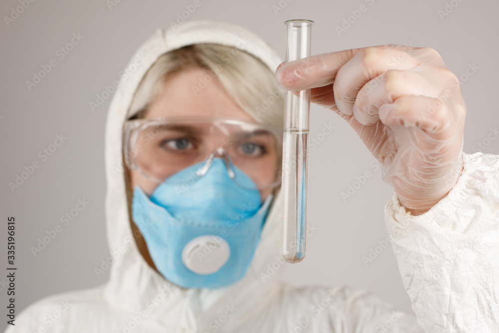 A girl in a protective suit and a respirator to protect health from viral, epidemic and infectious diseases. New Covid-19. Corona virus pandemic concept. Stop the virus. A girl in a protective suit and a respirator to protect health from viral, epidemic and infectious diseases. New Covid-19. Corona virus pandemic concept. Stop the virus.