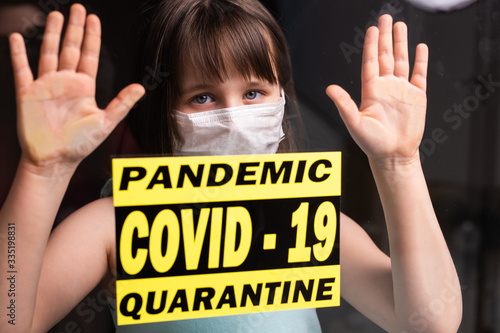 Stay at home. Sad lonely child in medical mask isolation in quarantine. Concept quarantine, prevention COVID-19, Coronavirus outbreak situation.