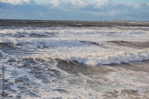 Ocean surface with waves and clouds in the background. Nature landscape, West coast of Ireland.