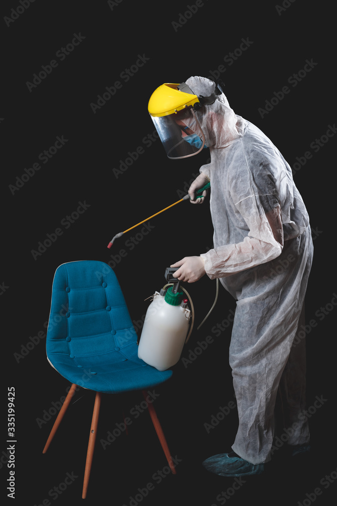 Naklejka premium Person with protective antiviral mask, suit, helmet and chemical decontamination sprayer bottle in home isolation.