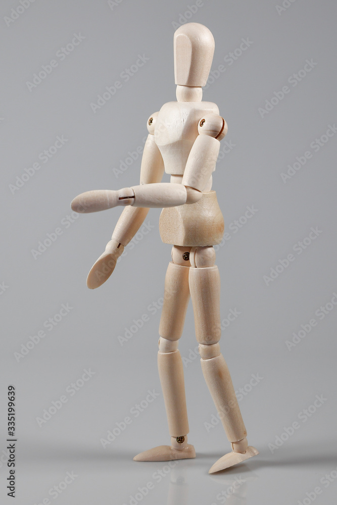 Wooden Mannequin on gray background Wooden Mannequin on gray background