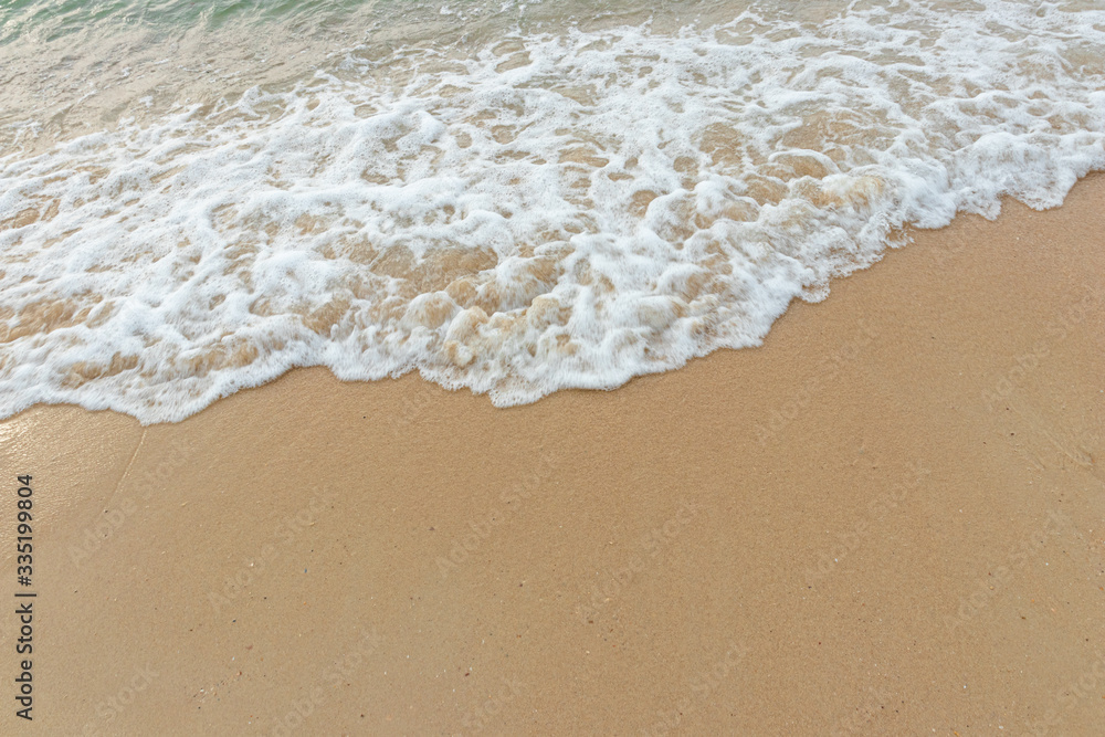 
Soft waves of the ocean on the sandy beach, summer beach, soft wave bubbles on the sandy beach