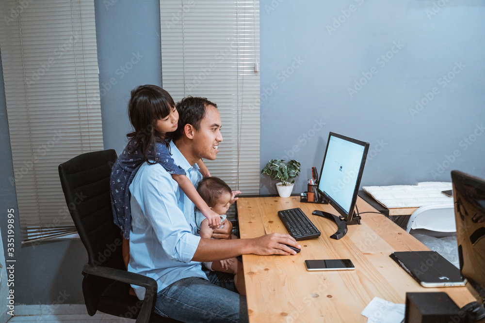 asian businessman working from home while babysitting. parent with child working at home asian businessman working from home while babysitting. parent with child working at home