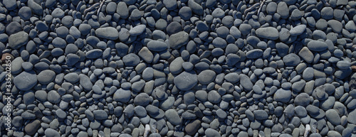 Photo Black pebbles background. Banner texture