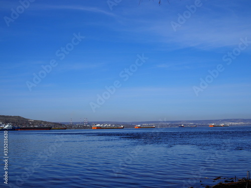 Cargo ships stand in the roadstead on the Volga River near Saratov