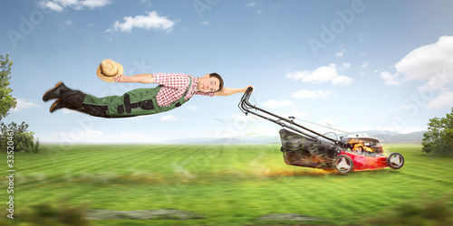 Funny gardener with a very powerful lawn mower photo