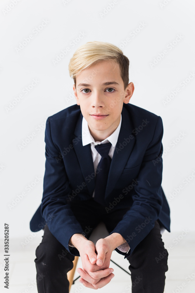 Portrait of stylish school boy teenager in white shirt and jacket against white background. Portrait of stylish school boy teenager in white shirt and jacket against white background.