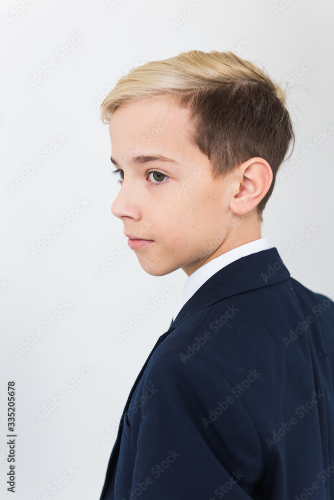 Portrait of stylish school boy teenager in white shirt and jacket against white background. Portrait of stylish school boy teenager in white shirt and jacket against white background.