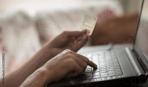 Man using laptop and holding credit card with payment online shopping concept
