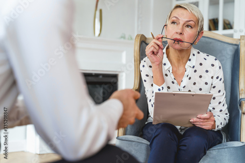 Professional female psychologist listening to a client