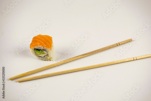 Natural Japanese food sushi with sticks and raw fish with rice.