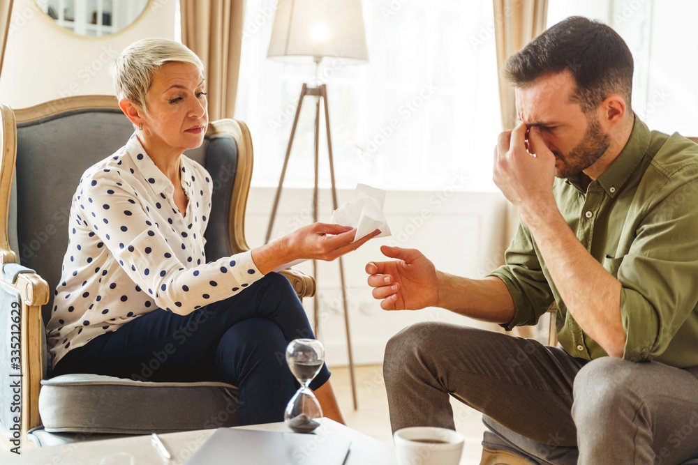 Fototapeta premium Frustrated man sitting in his psychoanalysts office
