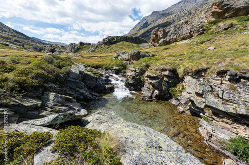 Mountains and stream at Nivolet plateau in Gran Paradiso National Park. Aosta Valley, Italy