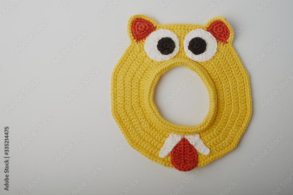 Fototapeta premium crochet Easter egg cup in chicken shape with easter eggs and greeen wool grass. white isolated background