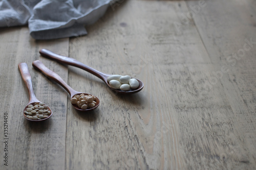 beans in broun spoons on a wooden rustic table