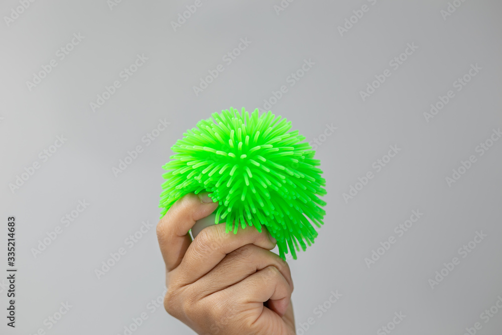 Hand holding green plastic toy isolated background. Hand holding green plastic toy isolated background.
