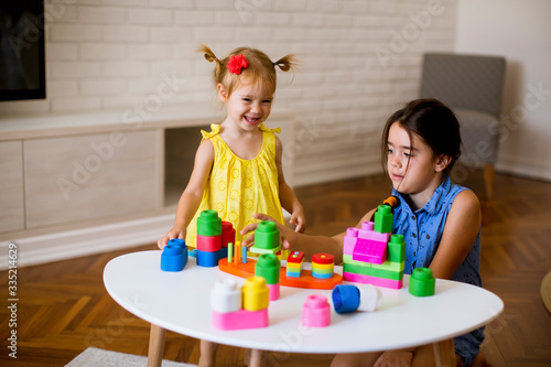 Two little girls play with ...