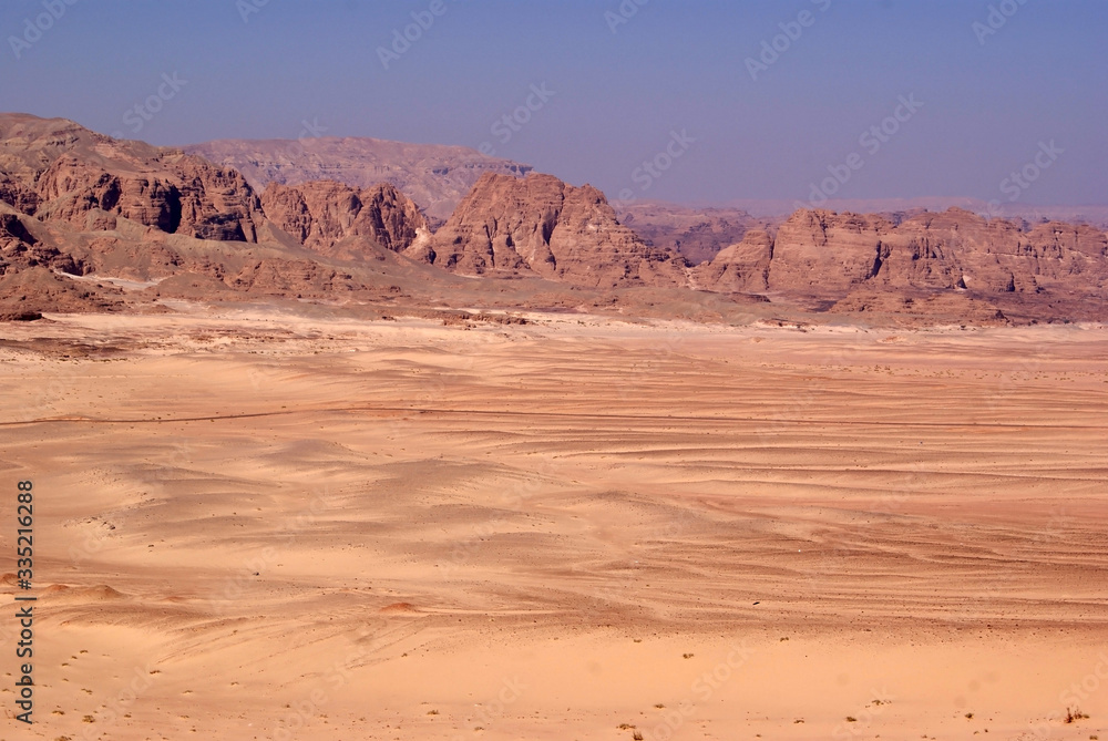 Fototapeta premium Beautiful panorama of the Sinai Desert. Mountains and sands of different shades. Clear blue sky