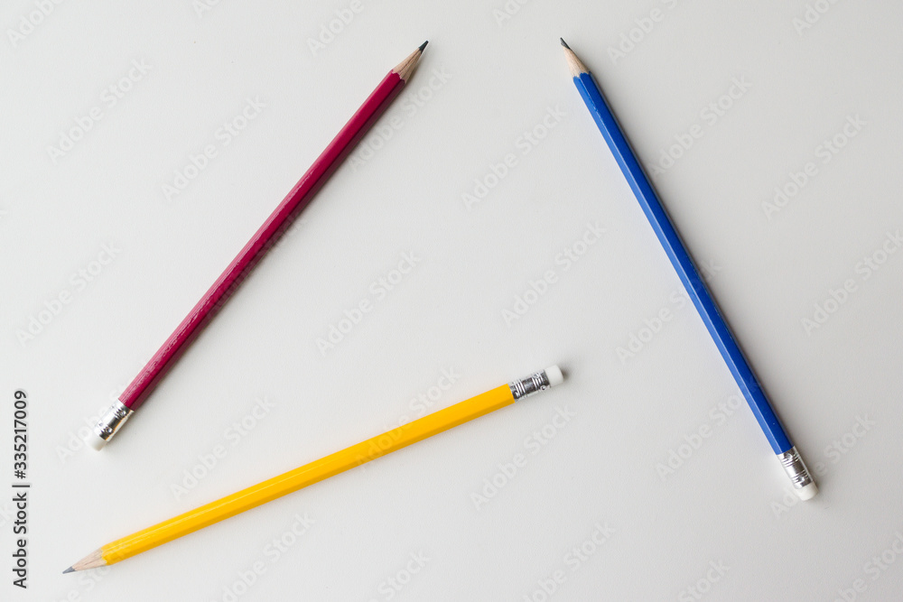 Three pencils on white background