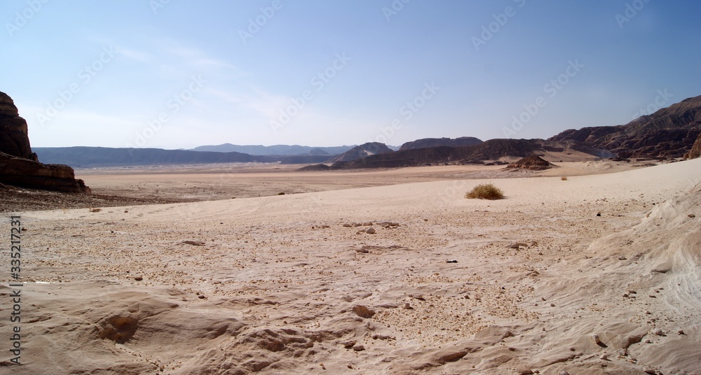 Beautiful panorama of the Sinai Desert. Mountains and sands of different shades. Clear blue sky Beautiful panorama of the Sinai Desert. Mountains and sands of different shades. Clear blue sky