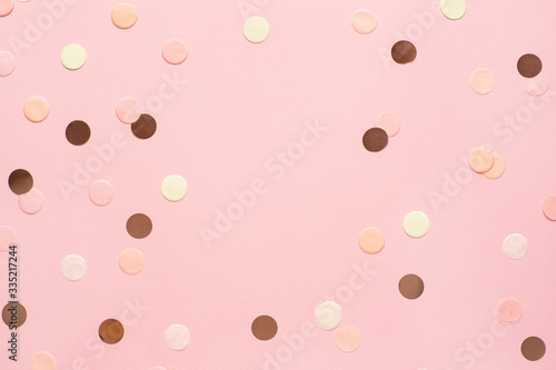 Pink,gold and yellow confetti on pink color paper background minimal style