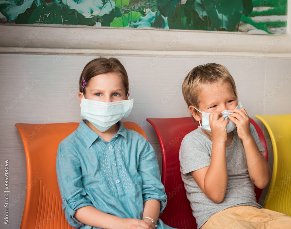 Kids wearing facial disposable mask. Virus protection
