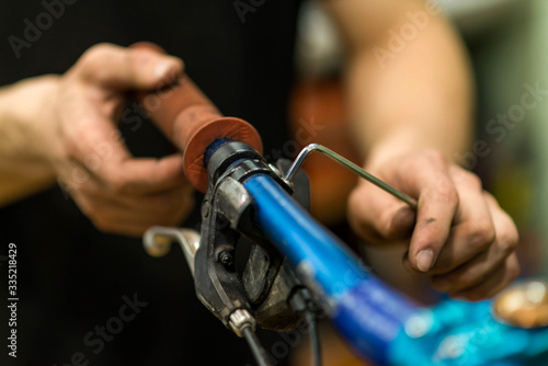 Cyclist mends a bicycle bar, closeup.