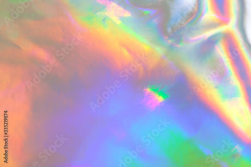 abstract holographic iridescent foil texture background with rainbow colored spots