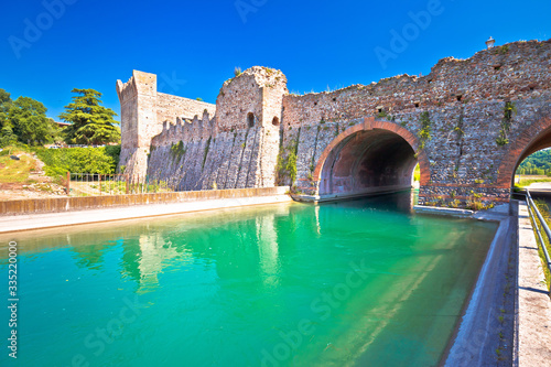 Mincio river in italian village of Borghetto and historic bridge view photo