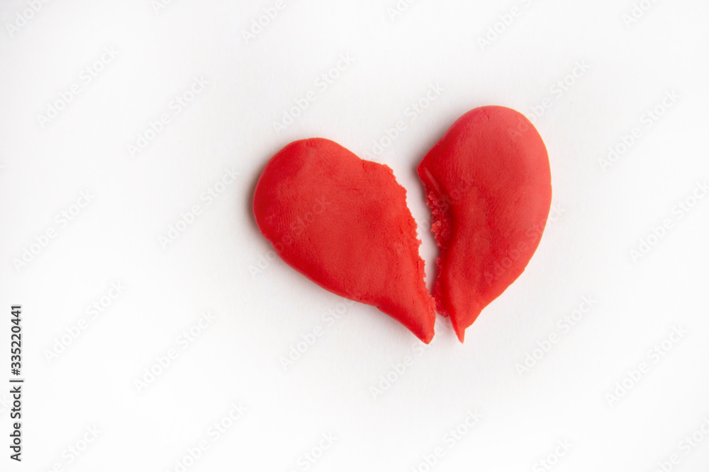 Fototapeta premium red heart split in two, quarrel concept. copyspace for text.