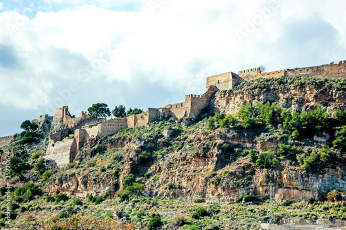old mountain fortress in spain, background with historical building © vyudin
