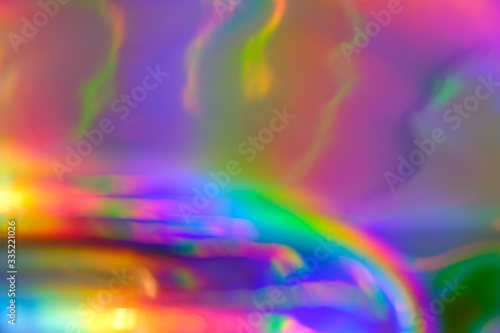 abstract holographic iridescent foil texture background with rainbow colored spots