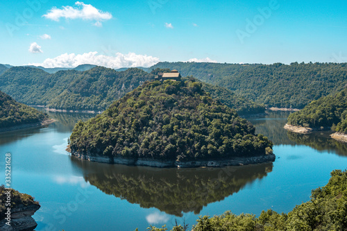 landscape of a church on the top of the mountain of the island. It is totally isolated, surrounded by the river and nature photo