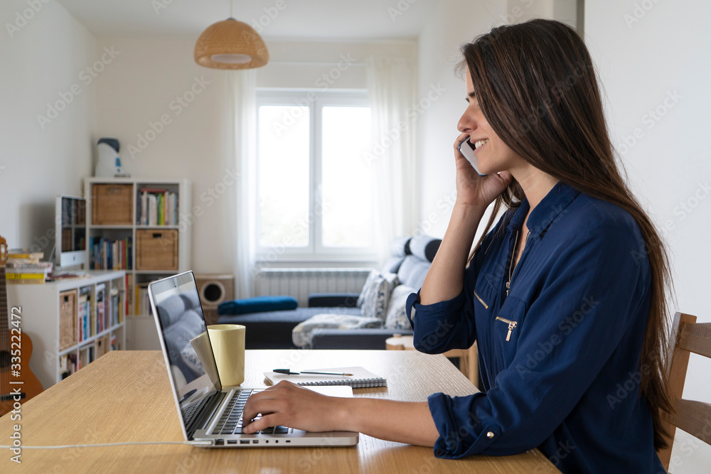 Smart working, young woman working from home on her laptop computer Smart working, young woman working from home on her laptop computer