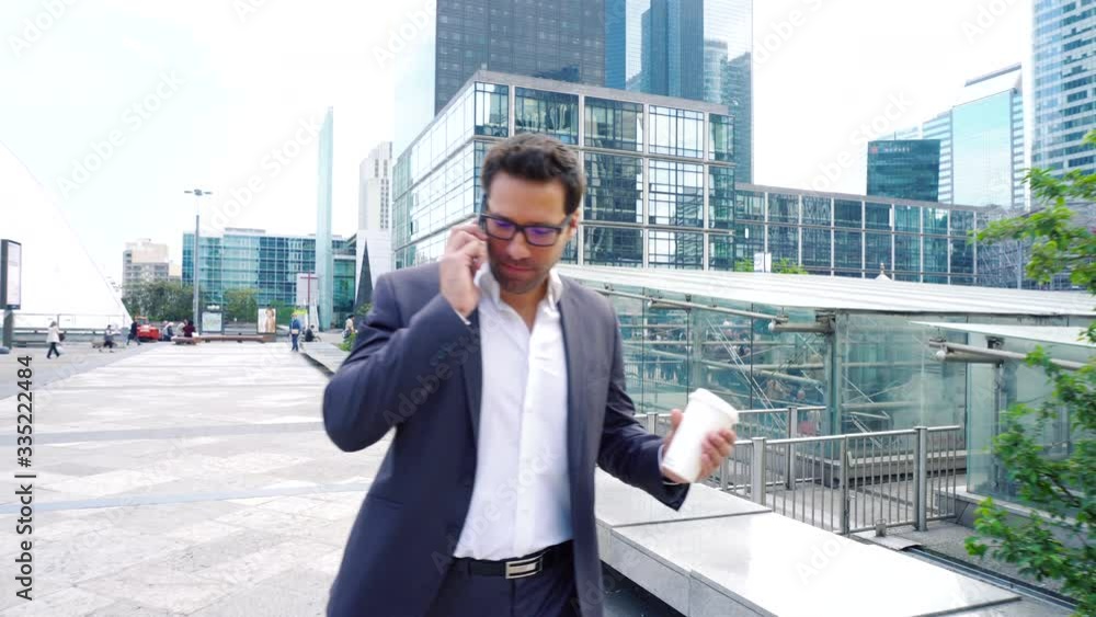 Businessman using a mobile phone in financial district, Businessman using a mobile phone in financial district,