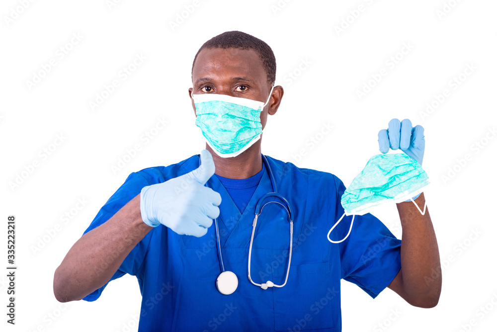 young male doctor showing his thumb while holding a medical mask