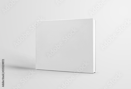 Fototapeta Naklejka Na Ścianę i Meble -  Closed white book template with realistic shadows, standing for presentation of design and advertising, front view.