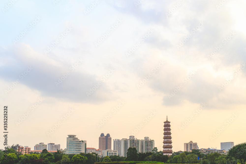 A panoramic view of the tall buildings, tourist attractions and the sky in Guangzhou, China in the evening