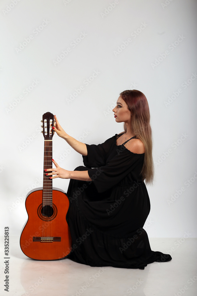 Pretty woman with a guitar on white background Pretty woman with a guitar on white background
