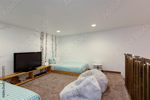 Bedroom interior  with painted birth trees, lght blue bedding, teenagers loft. photo