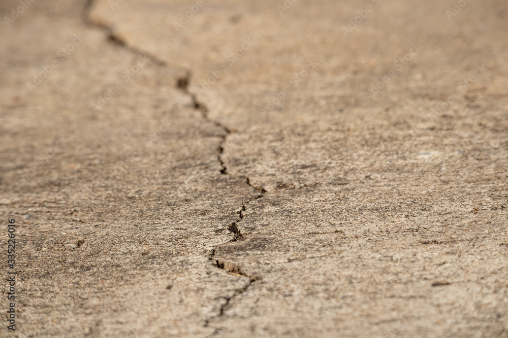 A cracks on the concrete floor. Surface of concrete covered with cracks,close up of crack cement road,concrete texture closeup background. A cracks on the concrete floor. Surface of concrete covered with cracks,close up of crack cement road,concrete texture closeup background.