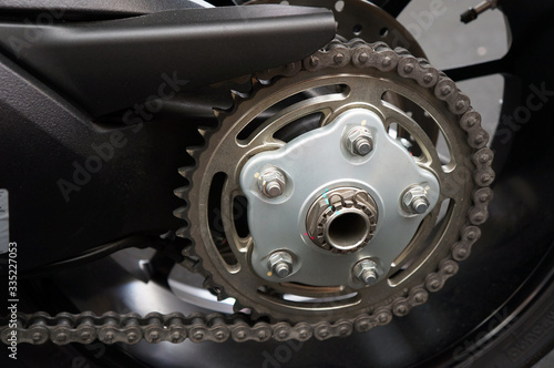Detail of a new motorcycle rear chain and gear 