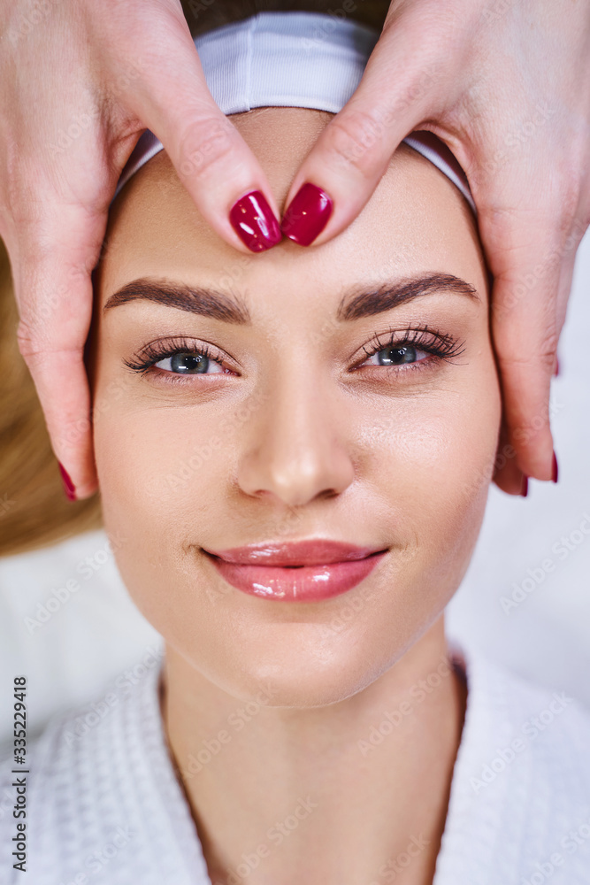 Jolly pretty girl at cosmetologist stock photo