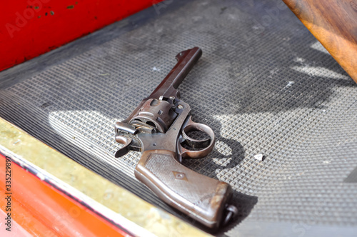Wall Mural A WW1 era revolver lying on the footwell of an old car
