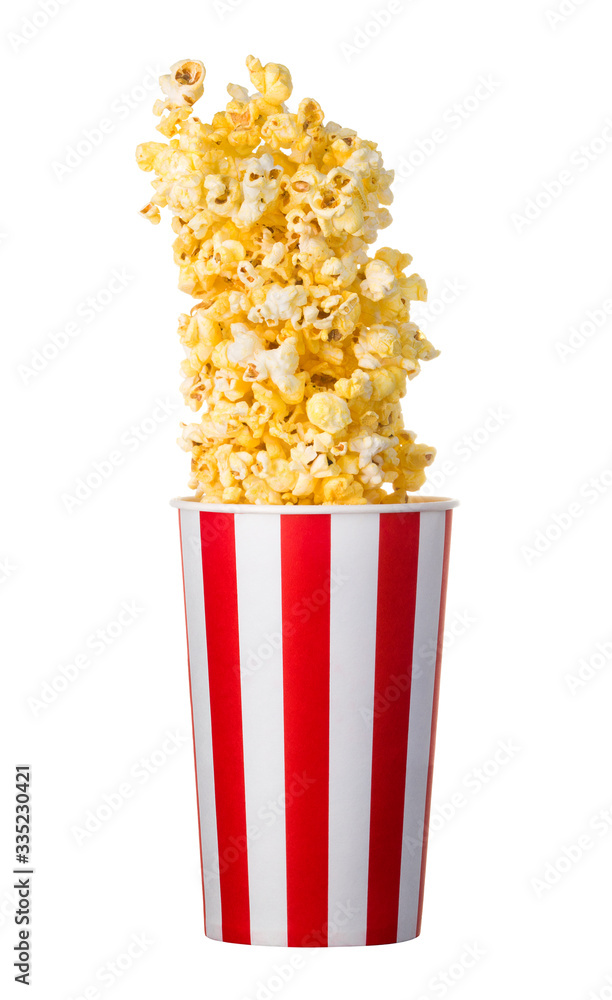 Flying popcorn from paper striped bucket isolated on black background Flying popcorn from paper striped bucket isolated on black background