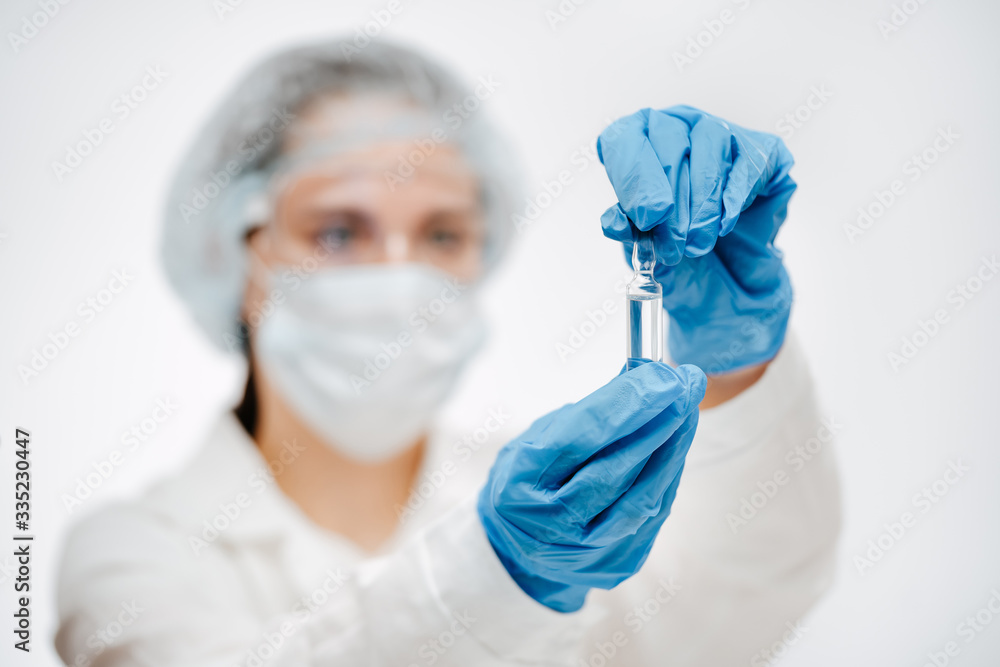 medical worker in gloves holding medicine to cure coronavirus in clinic closeup focus on hands with ampule medical worker in gloves holding medicine to cure coronavirus in clinic closeup focus on hands with ampule